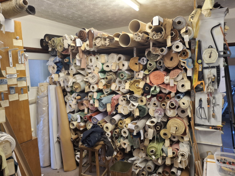 Rolls of fabric on shelves