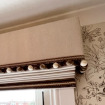 Customers fabric covered pelmet with bobble fringe over roman blind